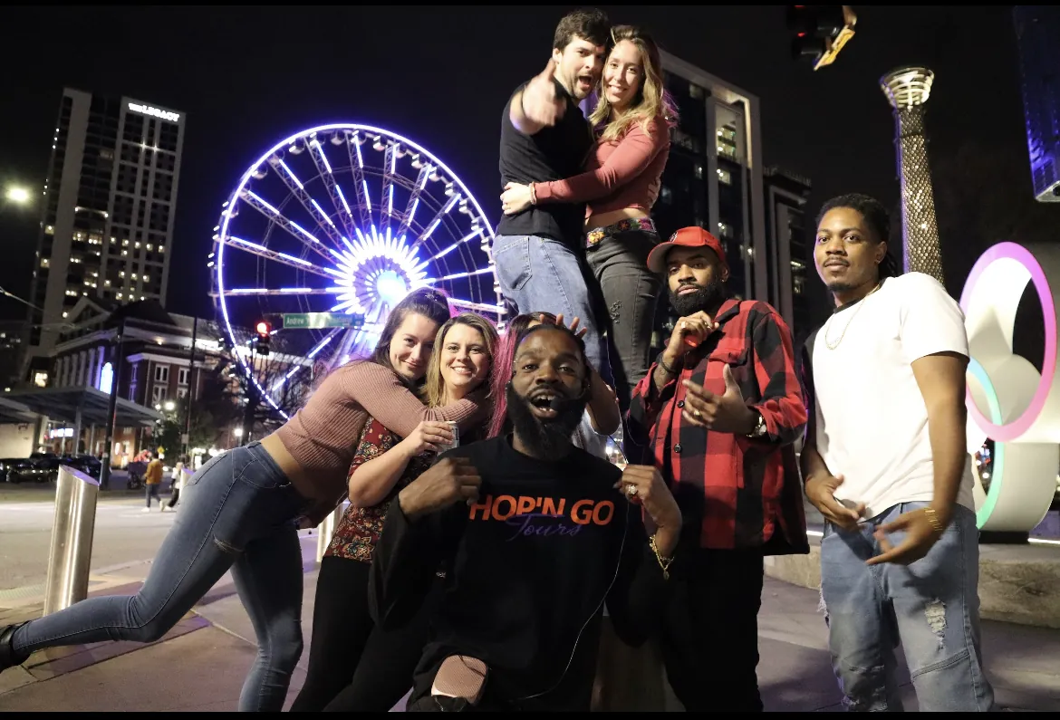 Guests celebrating by the SkyView wheel at night