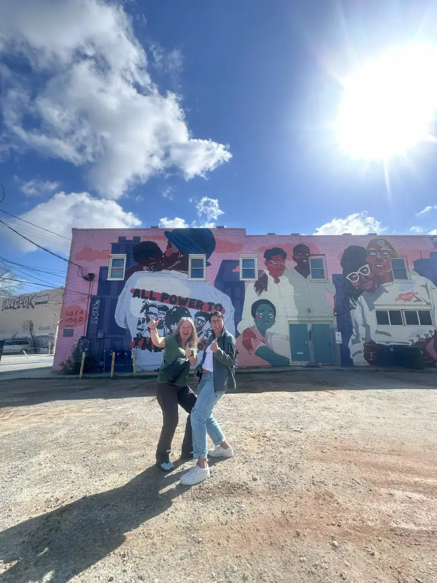 Guests in front of a large mural
